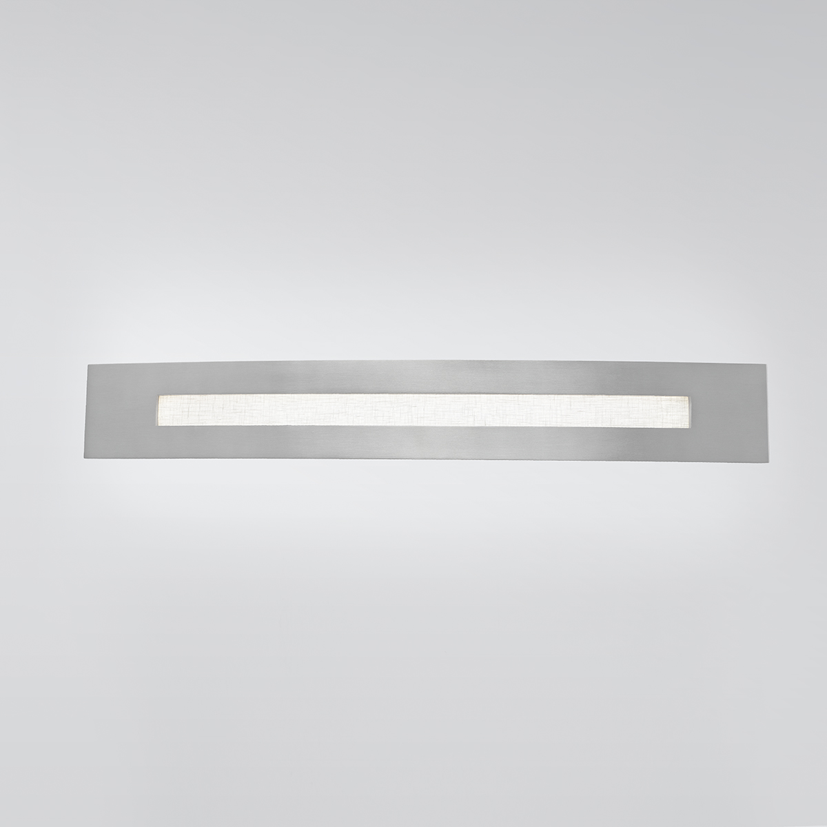 A long, horizontal, multi-sided wall sconce with diffuse light cutouts 