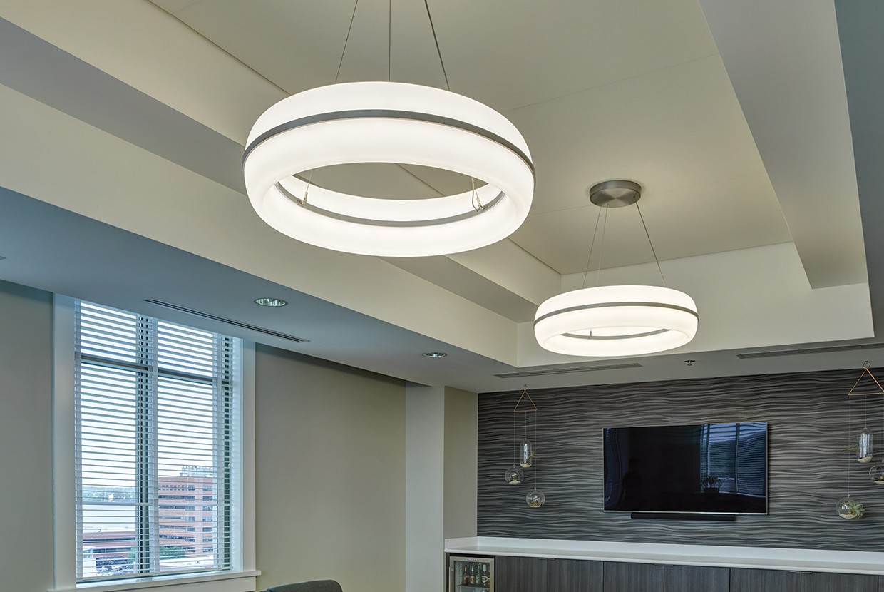 Meridian Round pendant is perfect for office lighting, seen here above a comfortable meeting area in a modern design office.