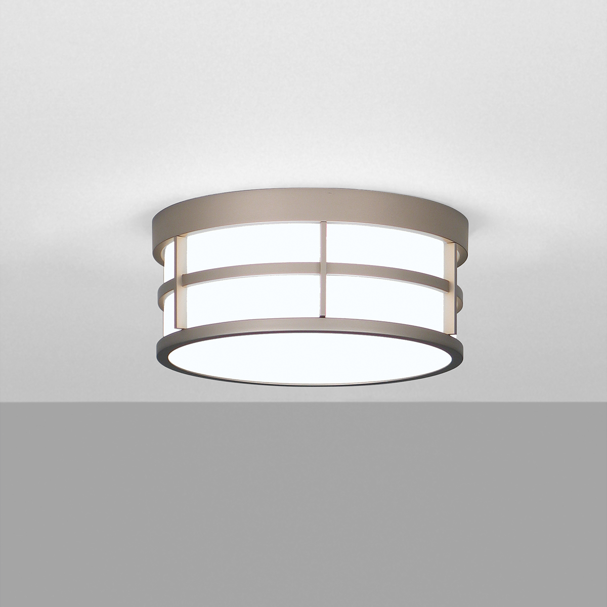 A ceiling mounted drum luminaire with cross bar accents 