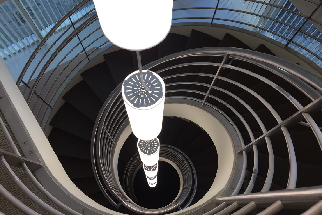 Custom pendant lighting installed in spiral stairwell