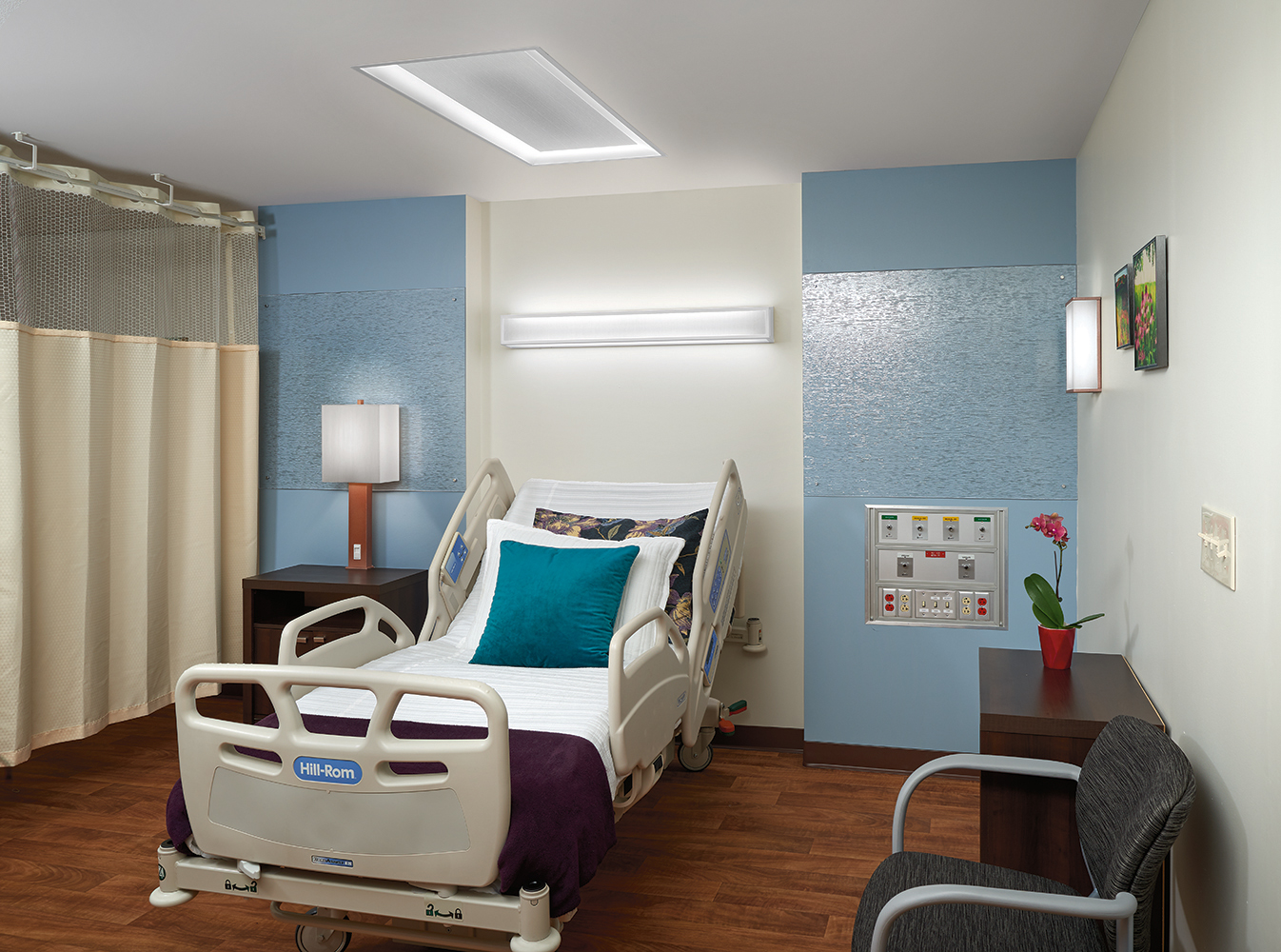 Serenity emits comforting overbed light and a matching table lamp for modern patient room lighting design.