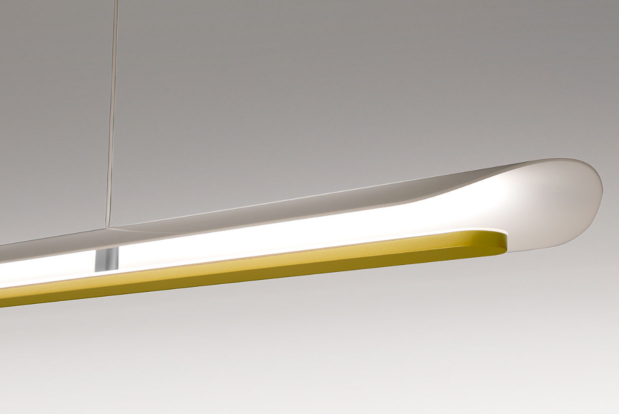 Detail of curved white and gold linear pendant light by Visa Lighting