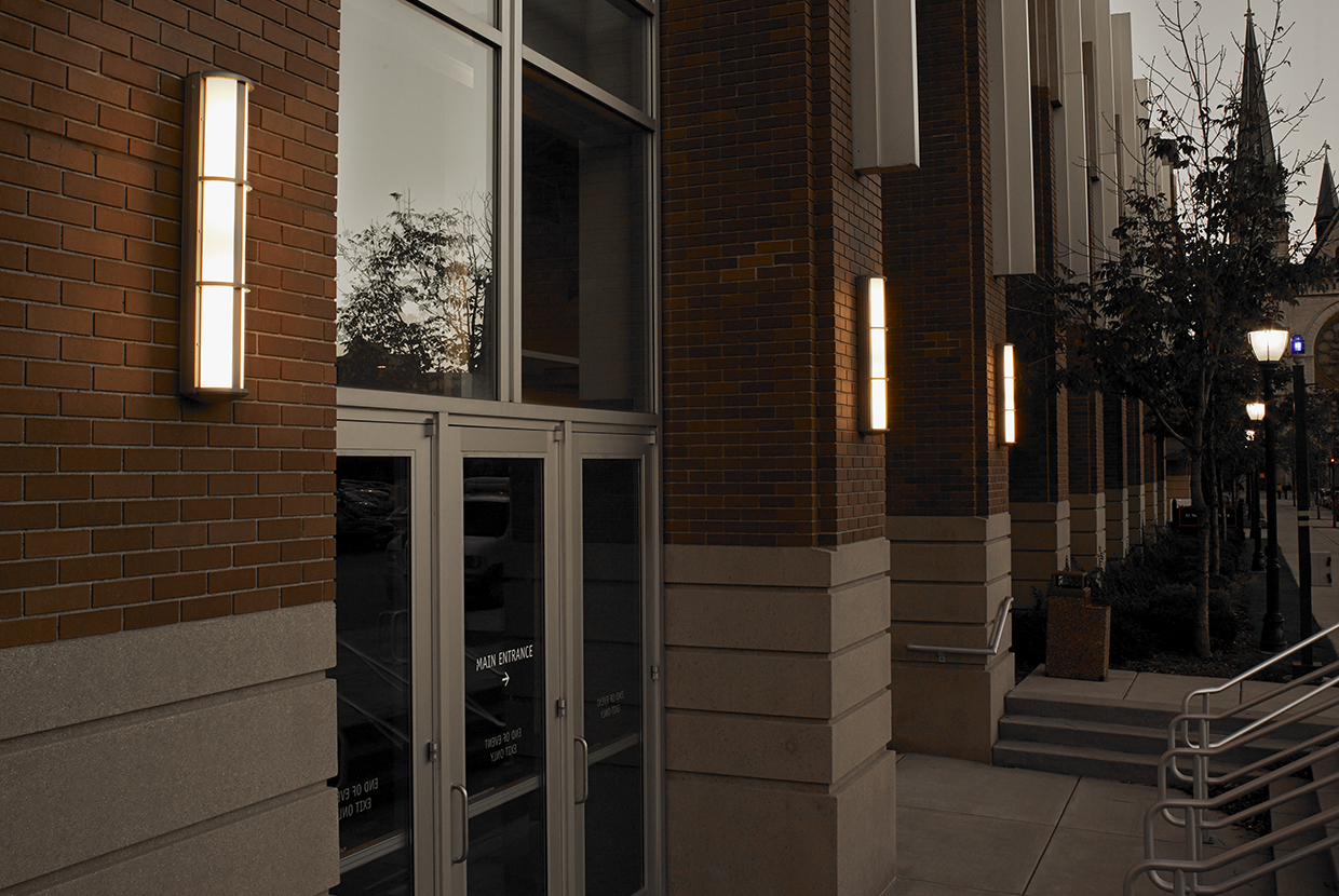 Avatar exterior lighting fixtures illuminate a campus library doorway with a classic, sophisticated aesthetic.