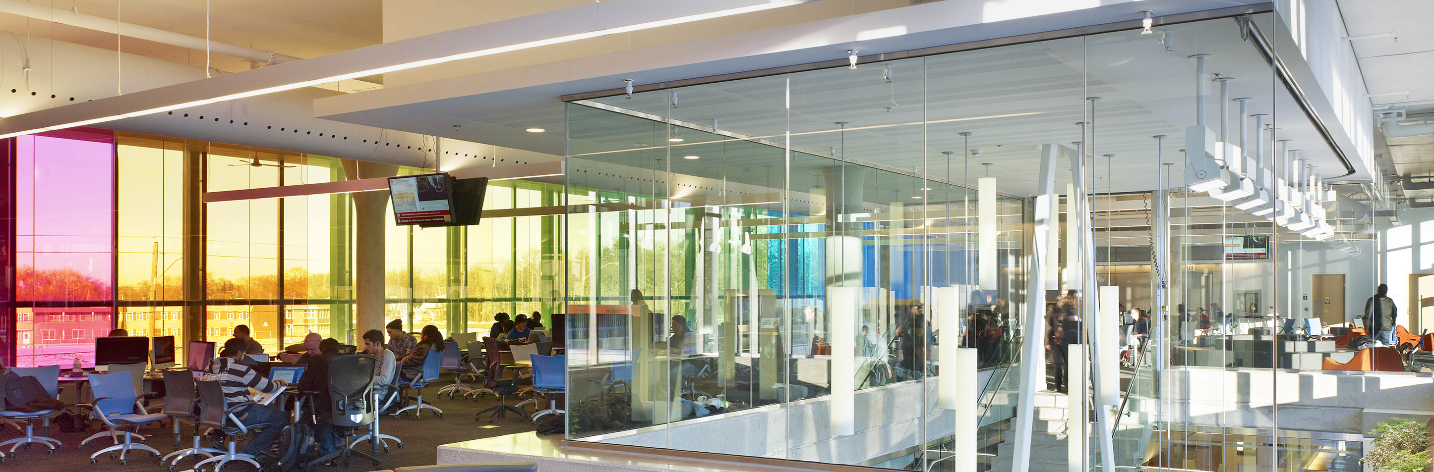 Sequence pendants enhance educational interior design in a large campus building atrium. 