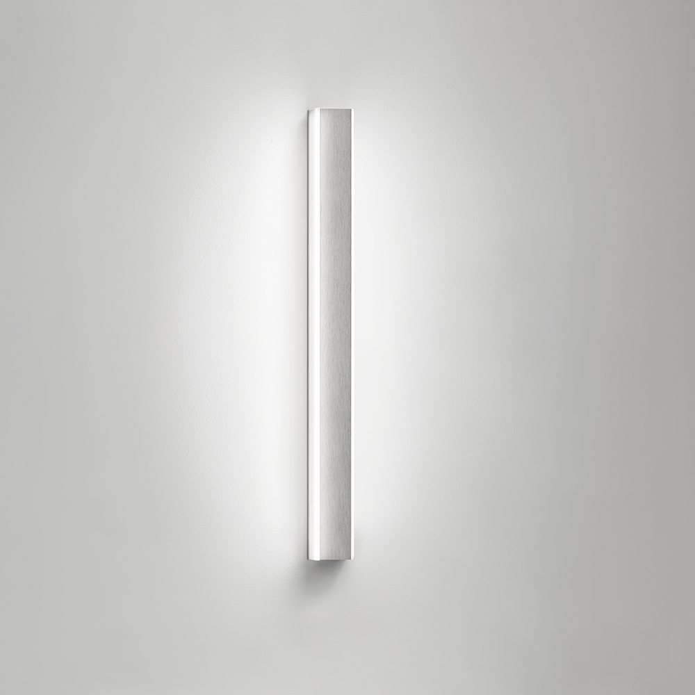 A thin, surface mounted luminaire with a linear body and soft side lighting