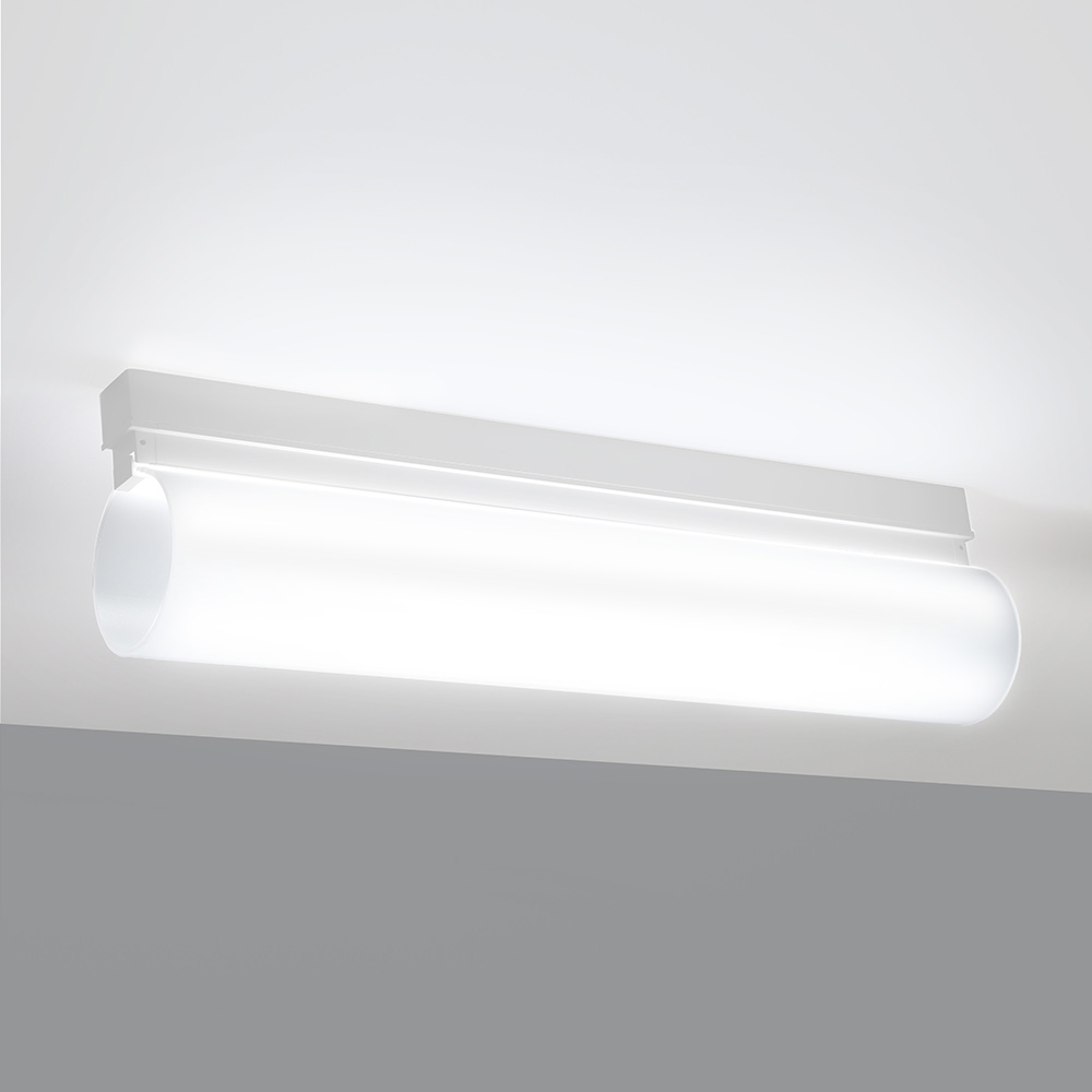 A thin linear surface-mounted luminaire with a fully luminous round body