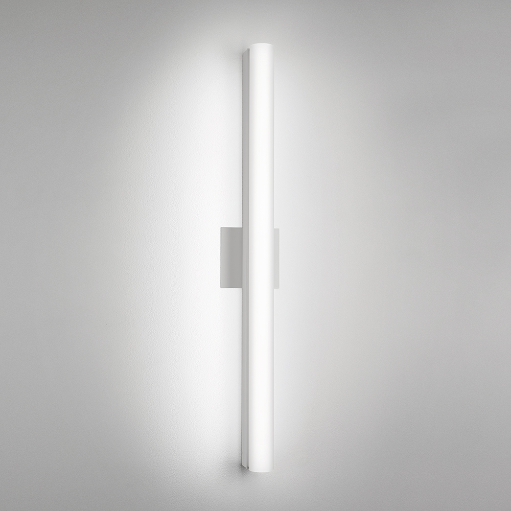 A thin linear surface-mounted luminaire with a fully luminous round body