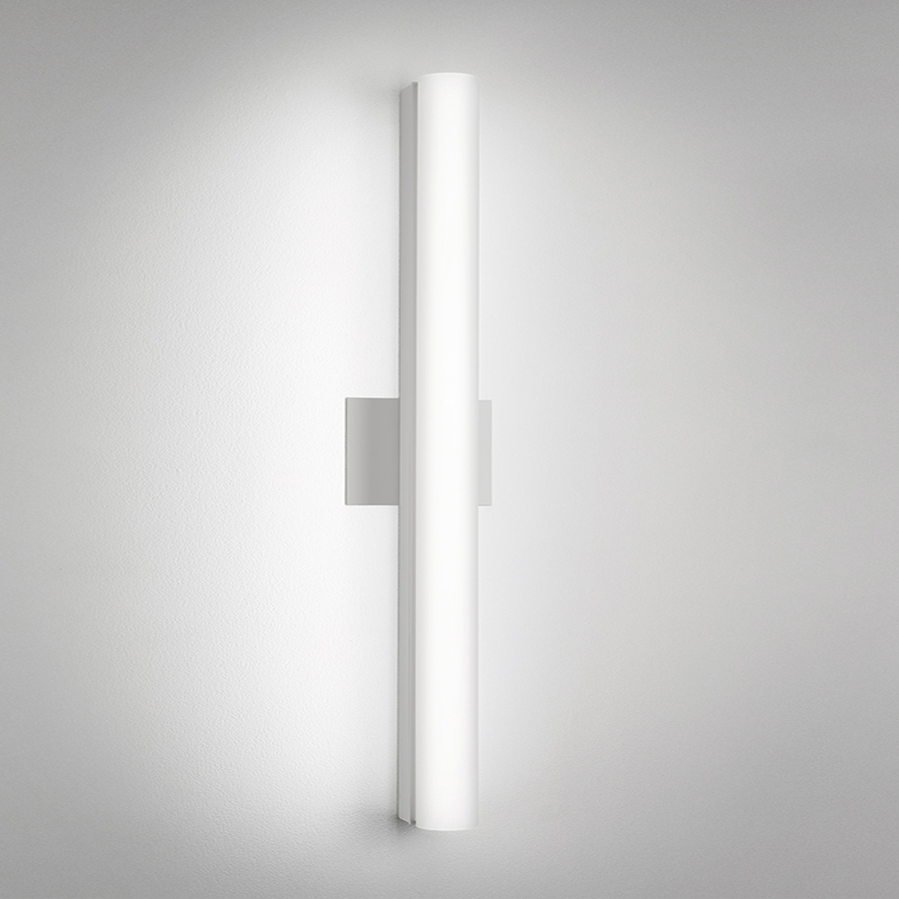 A thin linear surface-mounted luminaire with a fully luminous round body
