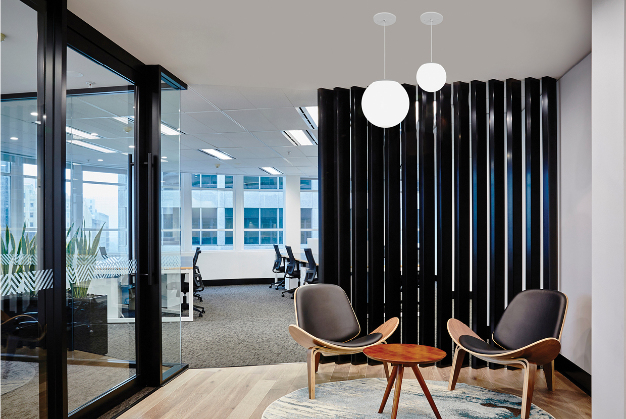 Two Zume globe pendant lights hung in mid century modern office waiting room