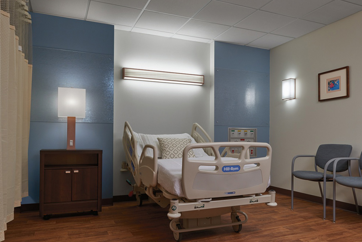 Hospital room with blue walls and beautiful healthcare lighting