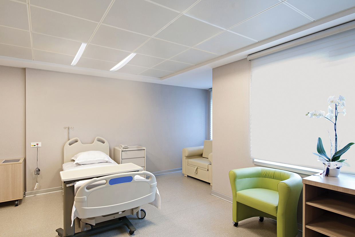 Unity overbed slot lights above patient bed in hospital room. 