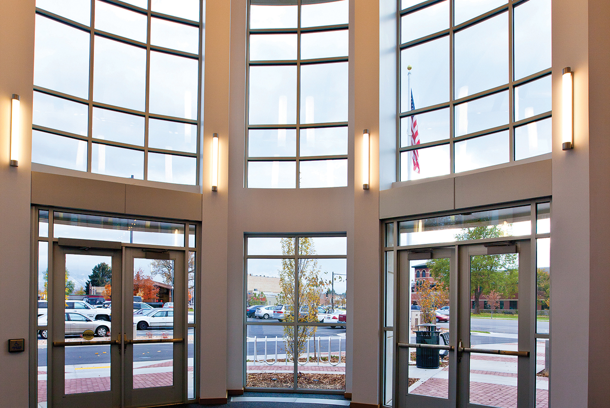 Asta wall sconces provide clean, modern lighting in a linear form for this library entryway.