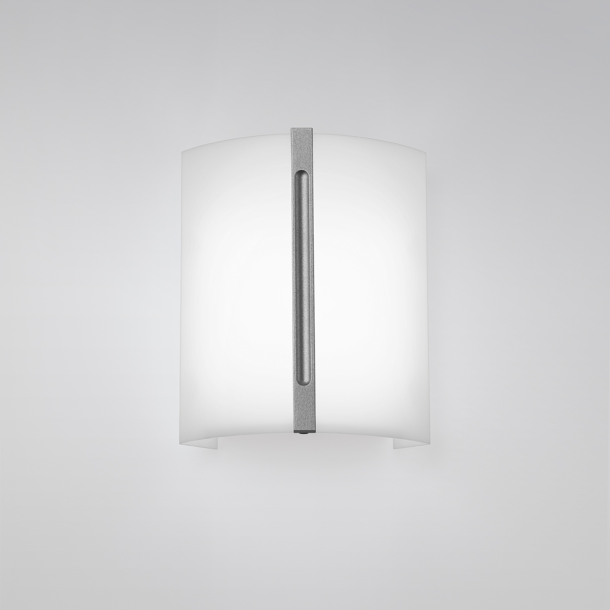 A small luminous wall sconce with a metal accent bar in the center