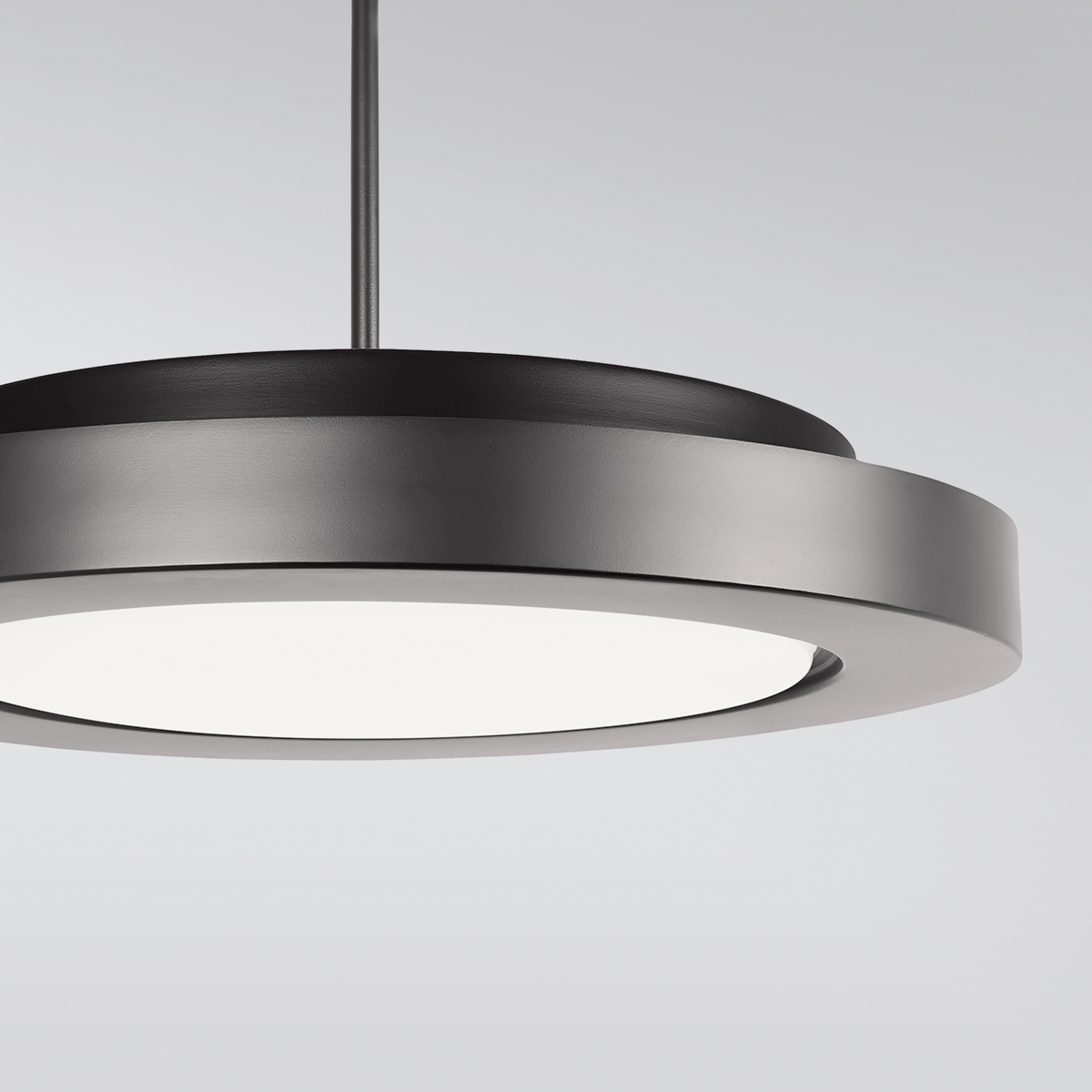 A circular pendant with a thick outer band, suspended by a stem