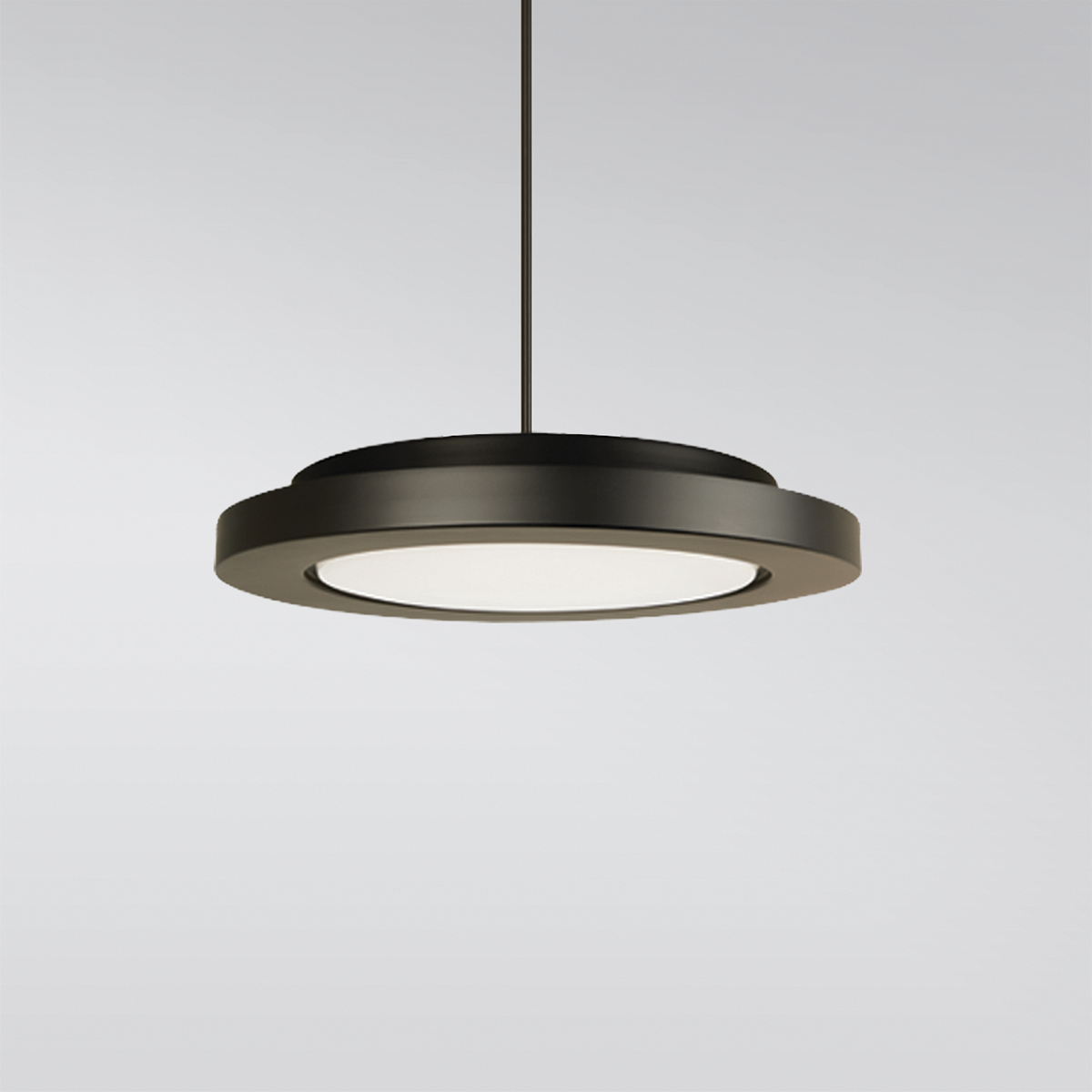 A circular pendant with a thick outer band, suspended by a stem