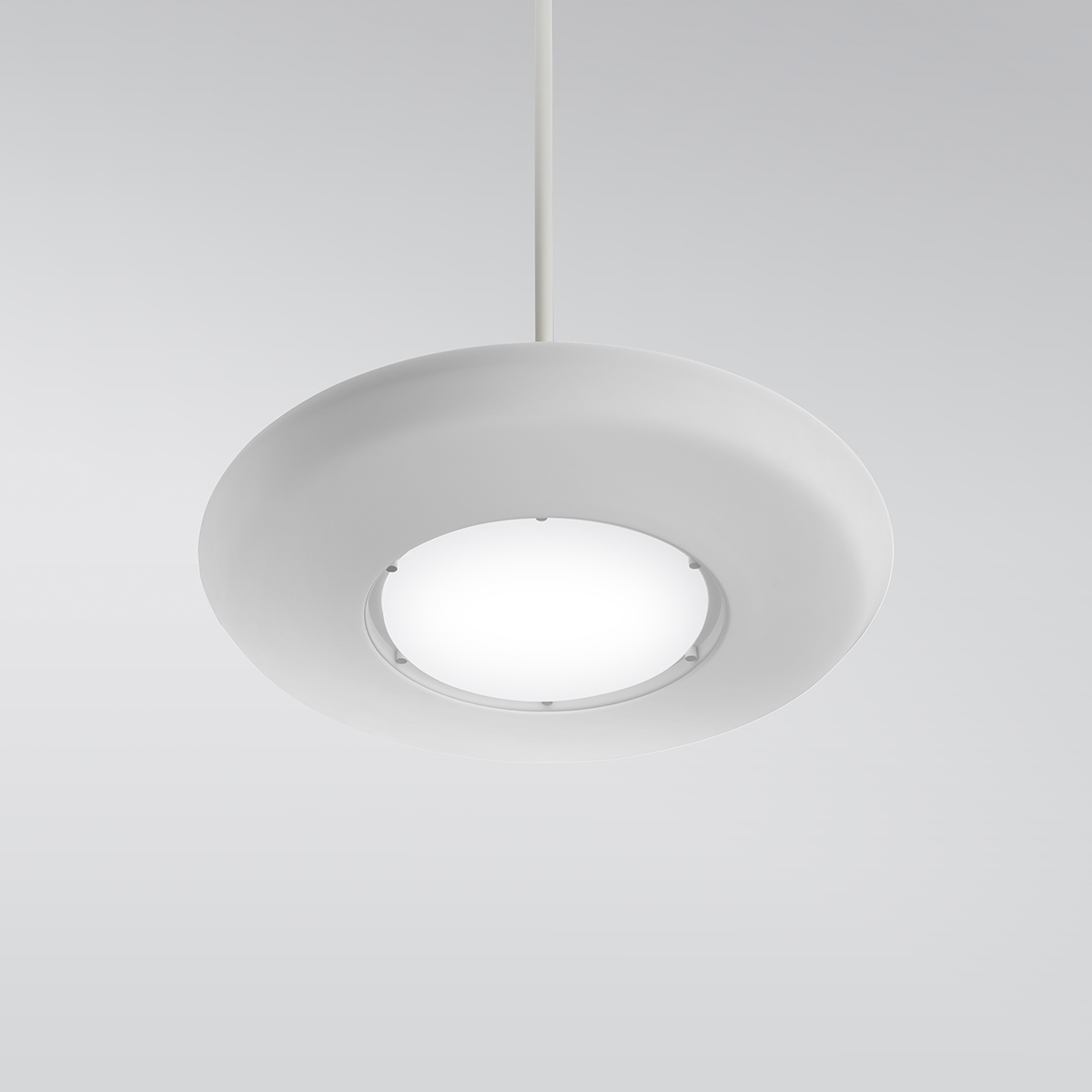 CP4450 Aries A round, disc-shaped pendant with a luminous downlight diffuser in the center