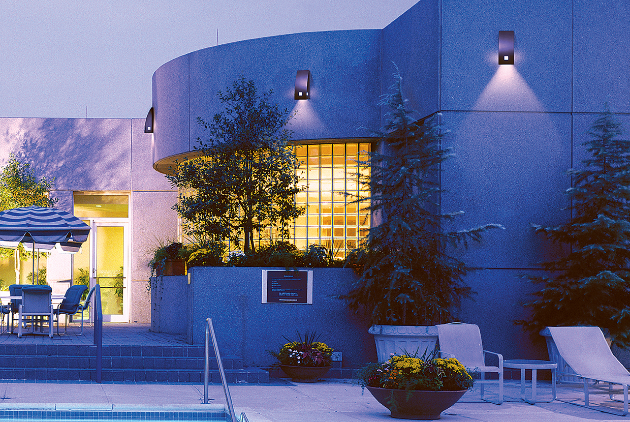 Cypress custom light fixtures on the exterior of a building near the pool