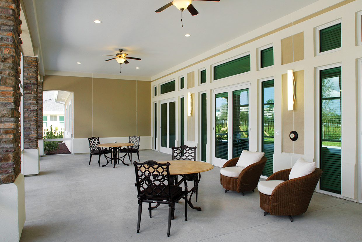 Outdoor patio with dining area and large outdoor sconce lighting. 