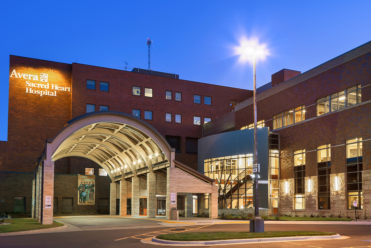 Hospital's brick facade with large outdoor sconces on entryway