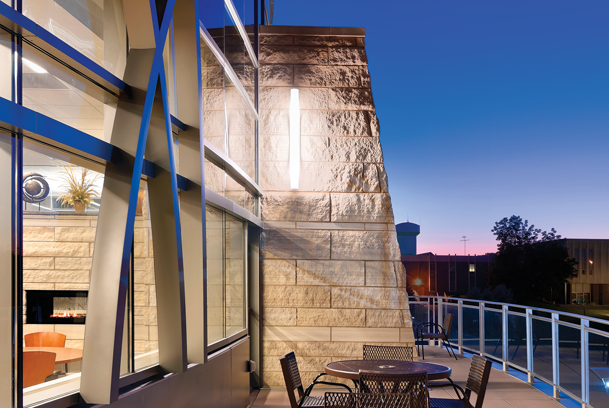 Outdoor patio on hospital with large outdoor sconce light and seating area. 