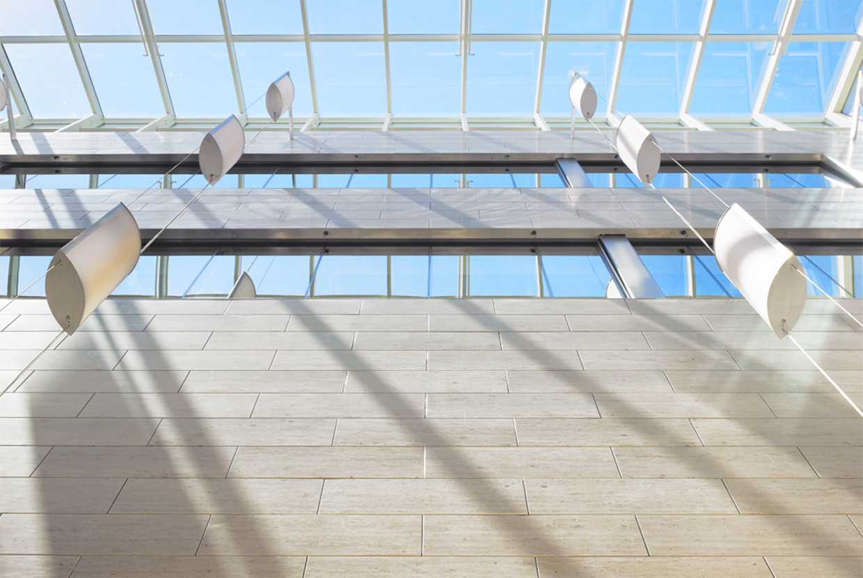 Elliptical pendant lights in glass atrium 