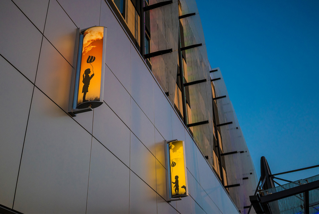 Customized outdoor lighting for Wisconsin Children's Hospital with printed lenses of children holding balloons