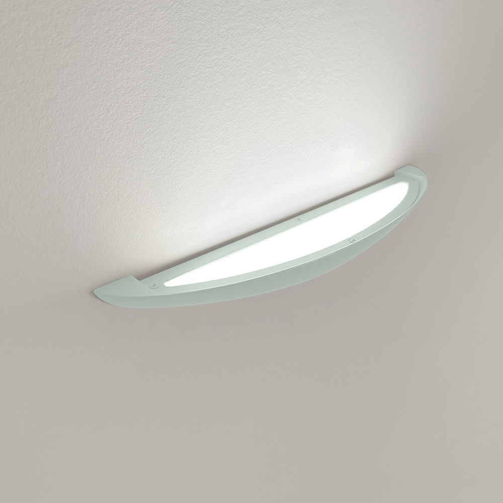 An uplighting wall sconce with a smooth, curved body 