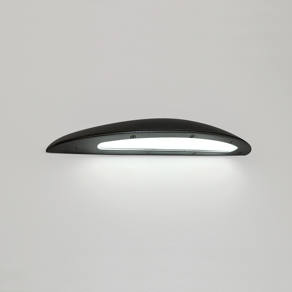 A down lighting wall sconce with a smooth, curved body