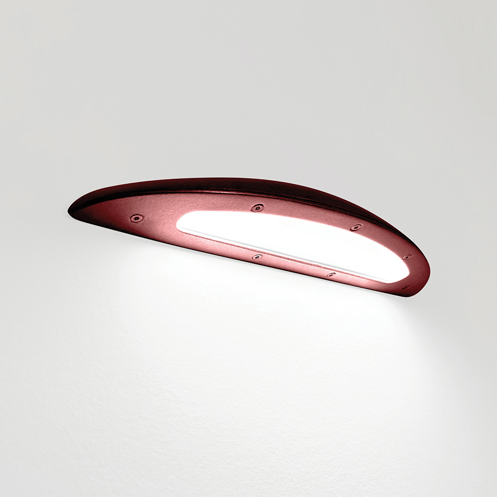 A down lighting wall sconce with a smooth, curved body