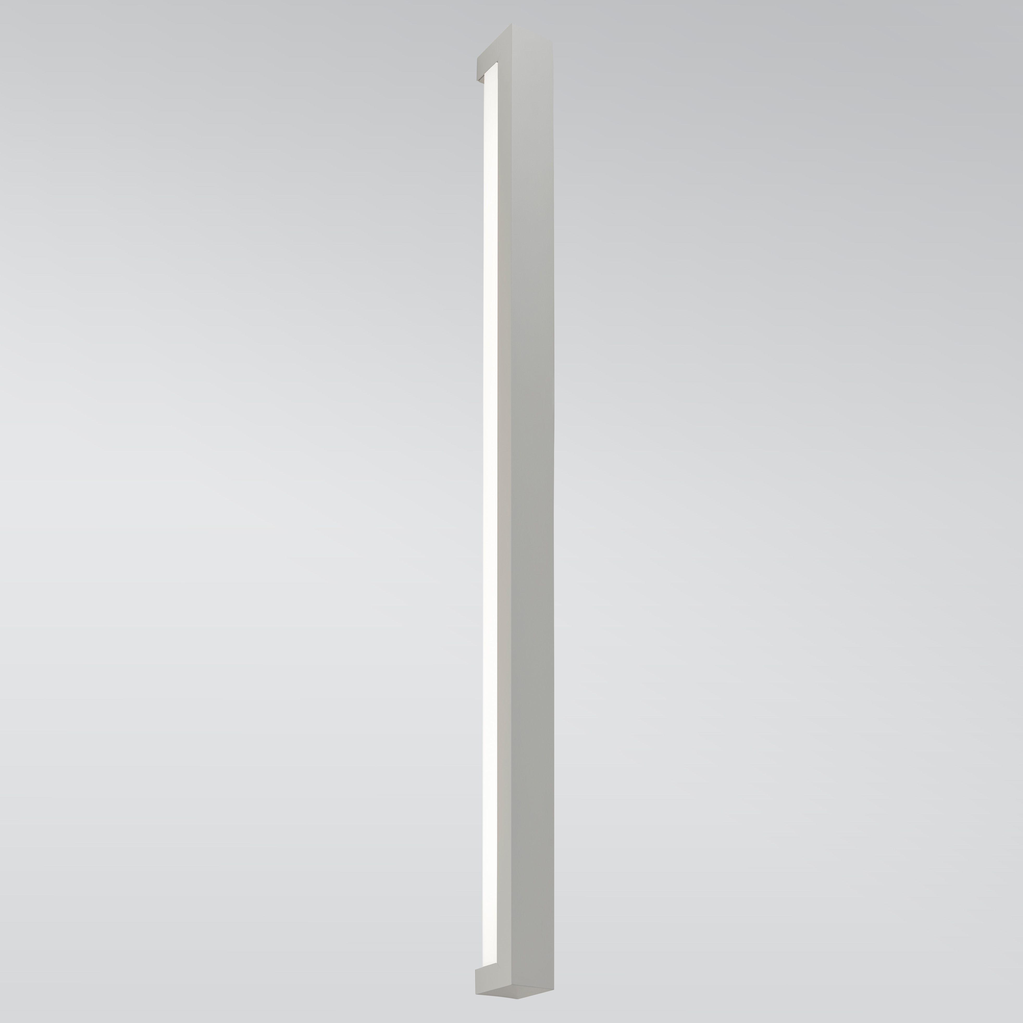 A linear wall sconce with a solid outer body and a luminous diffuser underneath