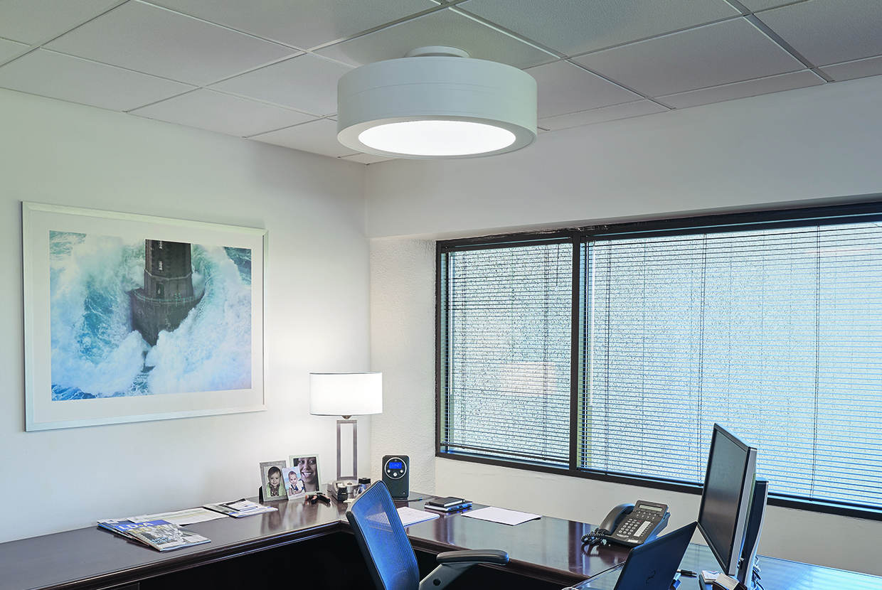 A ceiling-mounted drum luminaire with a light finish