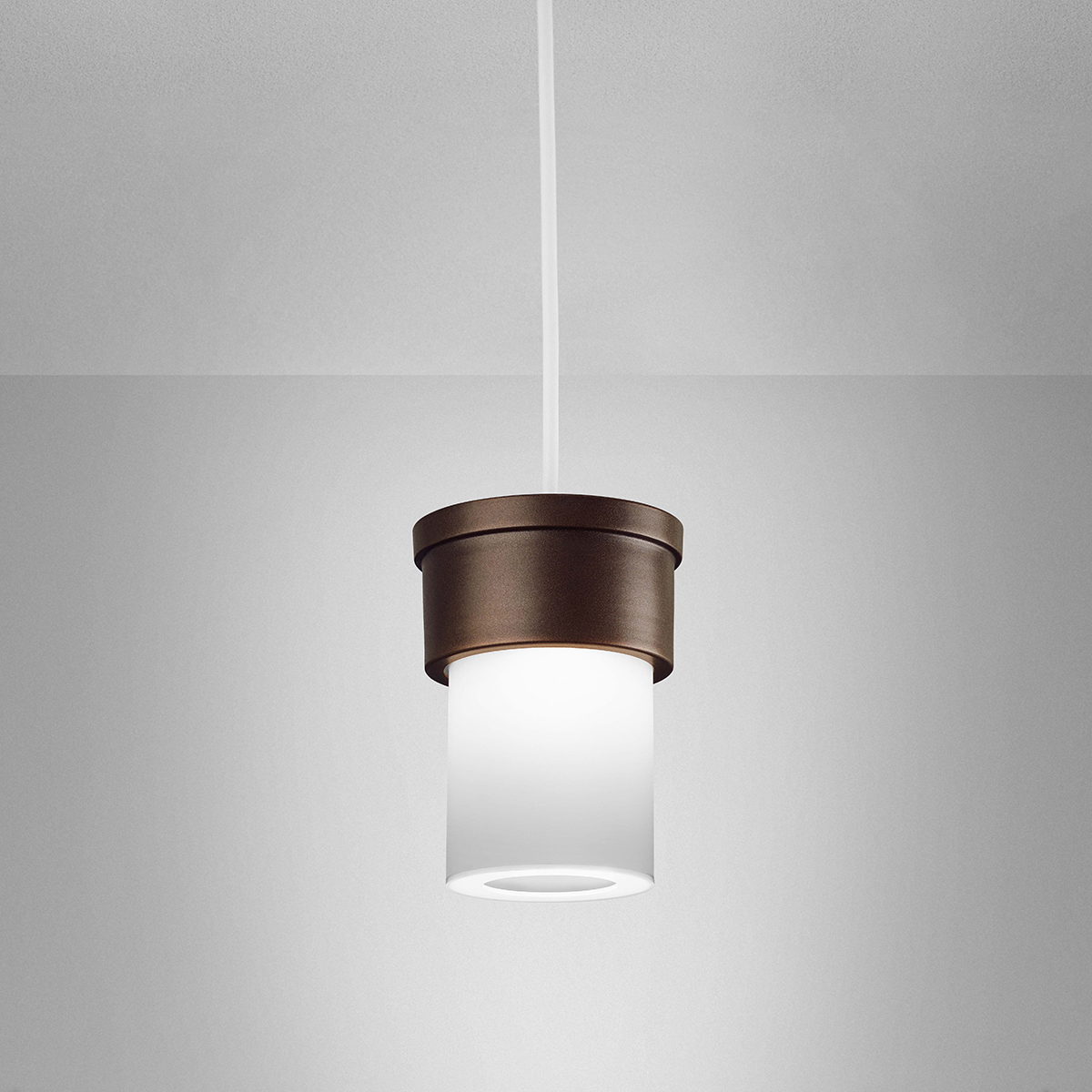 A small, luminous cylinder pendant with a solid base