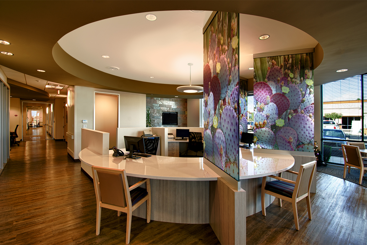 Aries pendant in a hospital lighting design above a circular, central nurses station with colorful dividing glass.