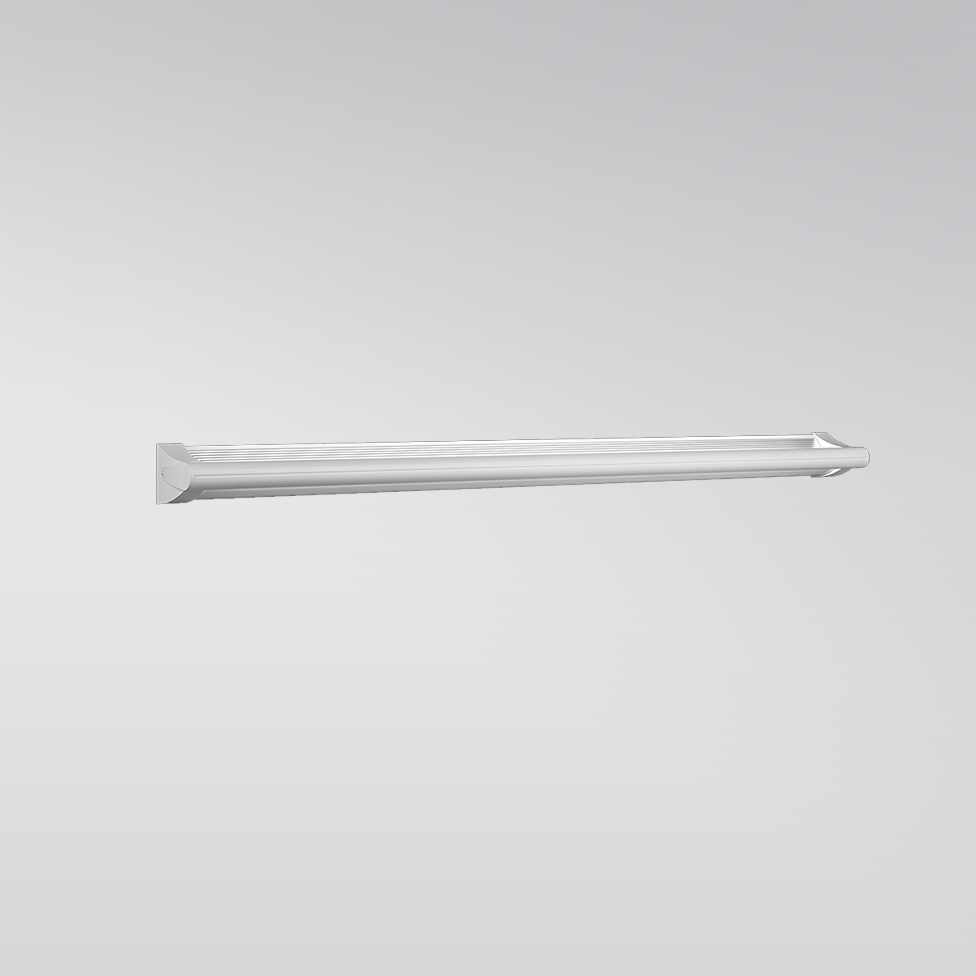 A surface mounted linear luminaire with a body that curves into the base with hidden indirect lighting