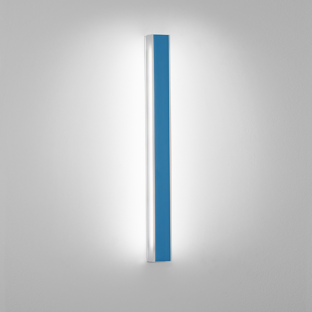 A thin, surface mounted luminaire with a linear body and soft side lighting