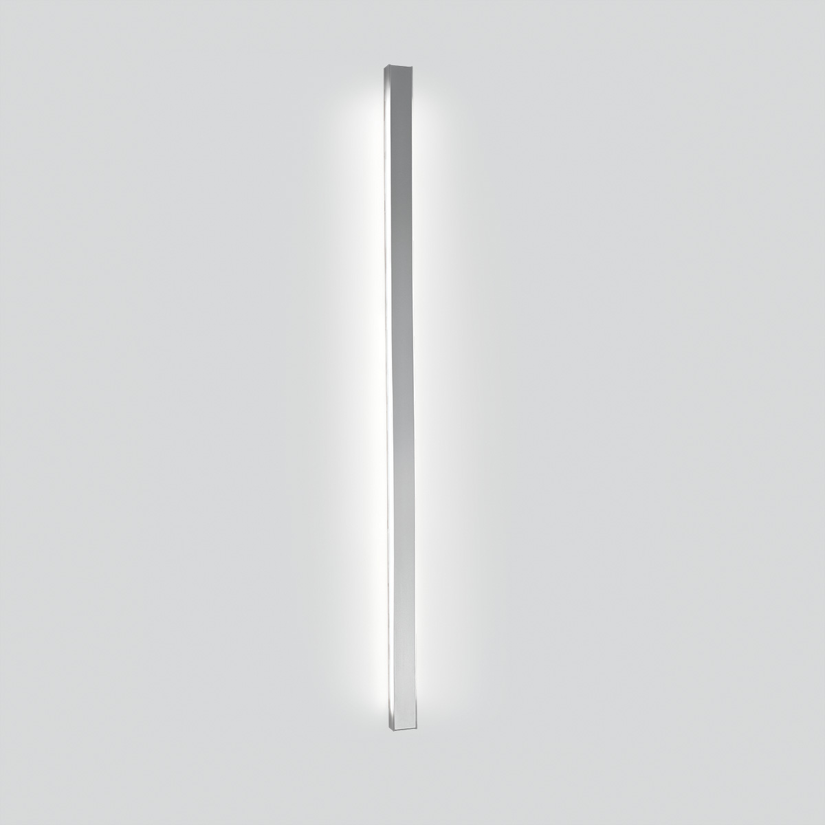 A thin, surface mounted luminaire with a linear body and soft side lighting