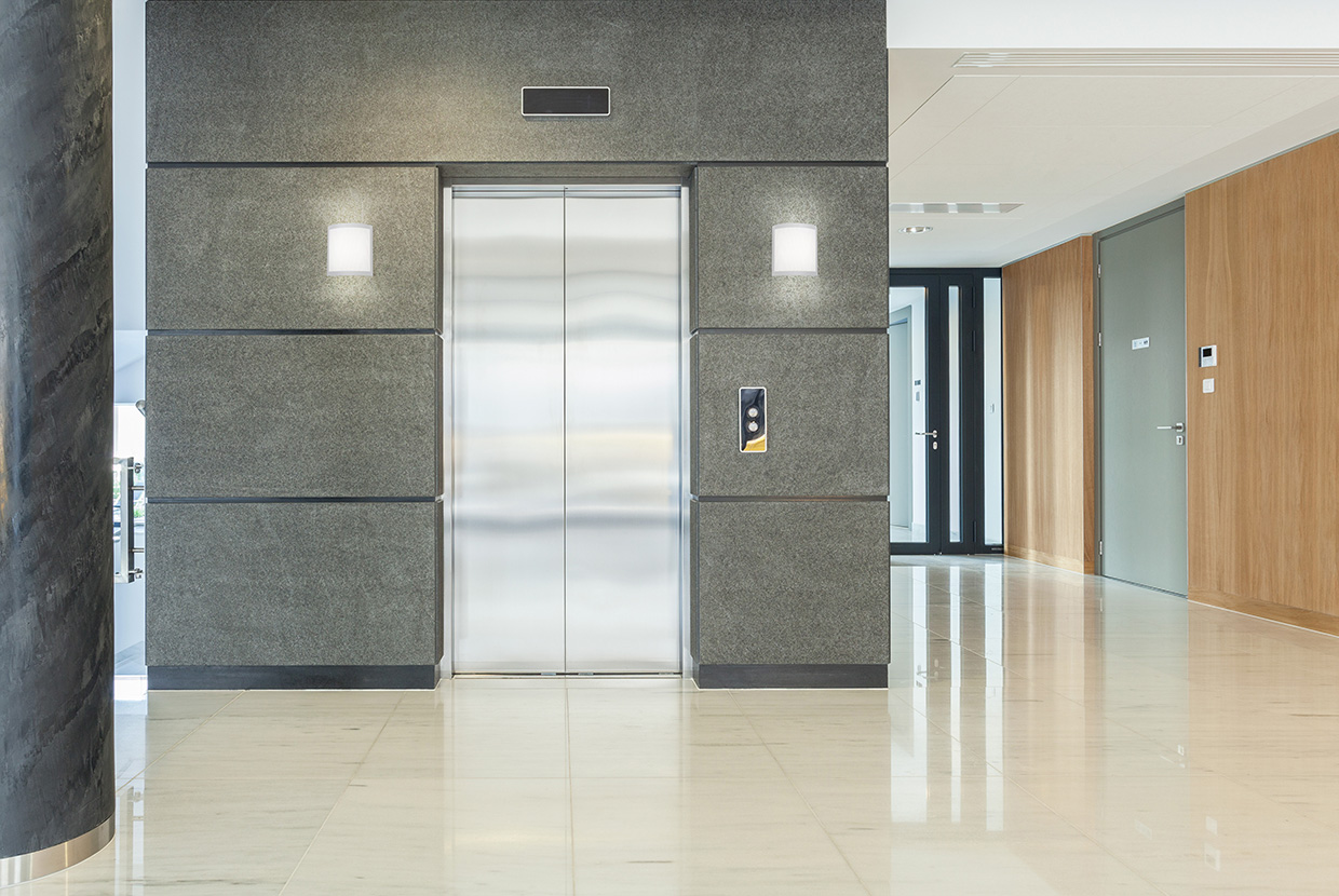 Two square indirect wall sconces with a curved, perforated front plate