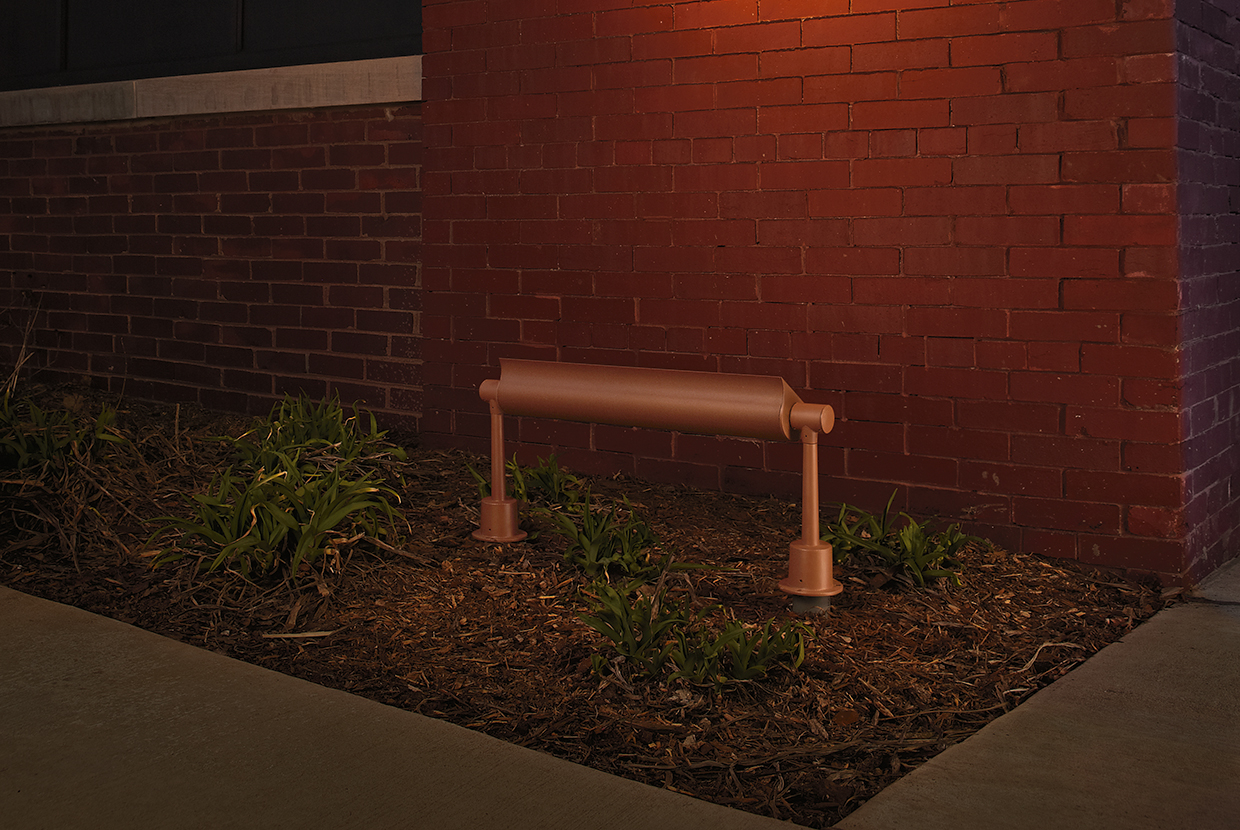 Advantus outdoor light fixtures illuminate an exterior wall along its upper edge, without revealing the light source. 
