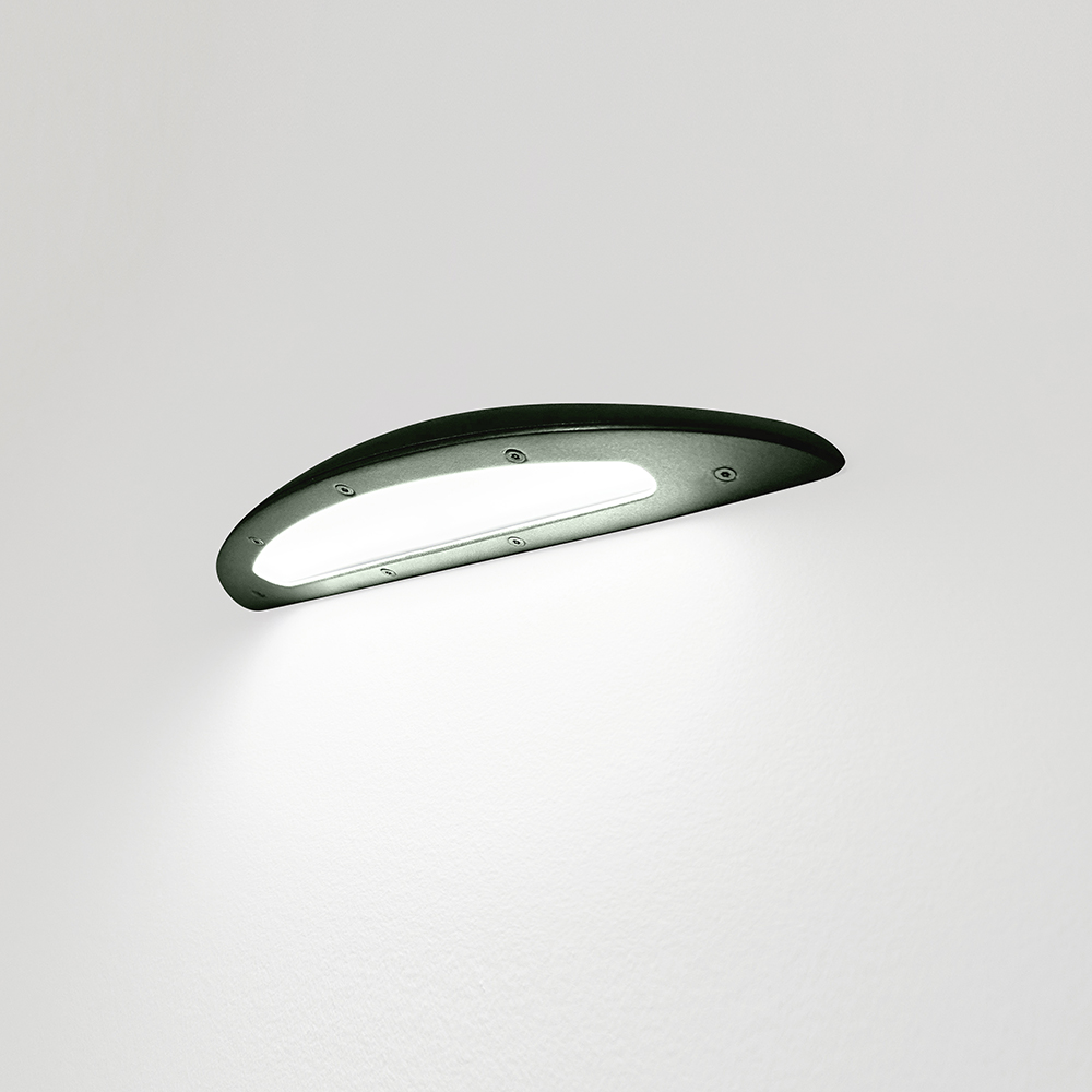 A down lighting wall sconce with a smooth, curved body