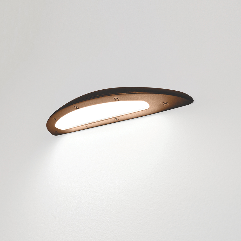 A down lighting wall sconce with a smooth, curved body