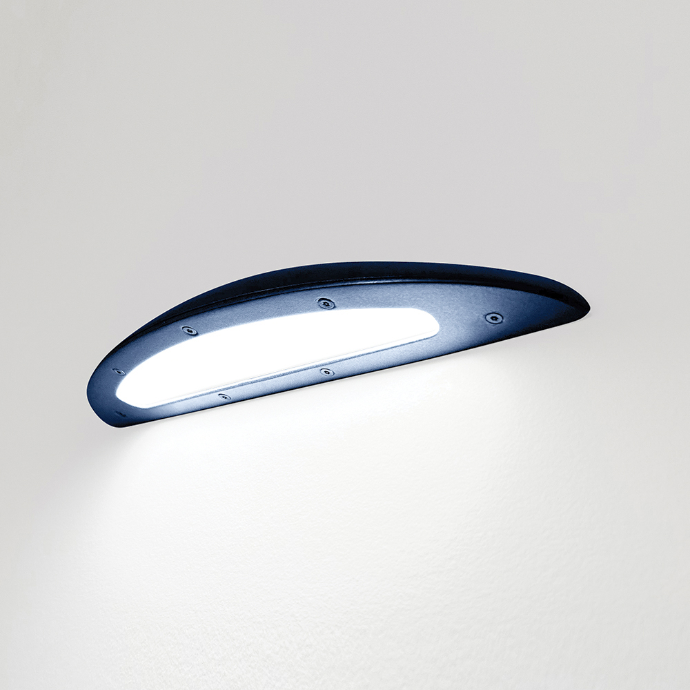 A down lighting wall sconce with a smooth, curved body