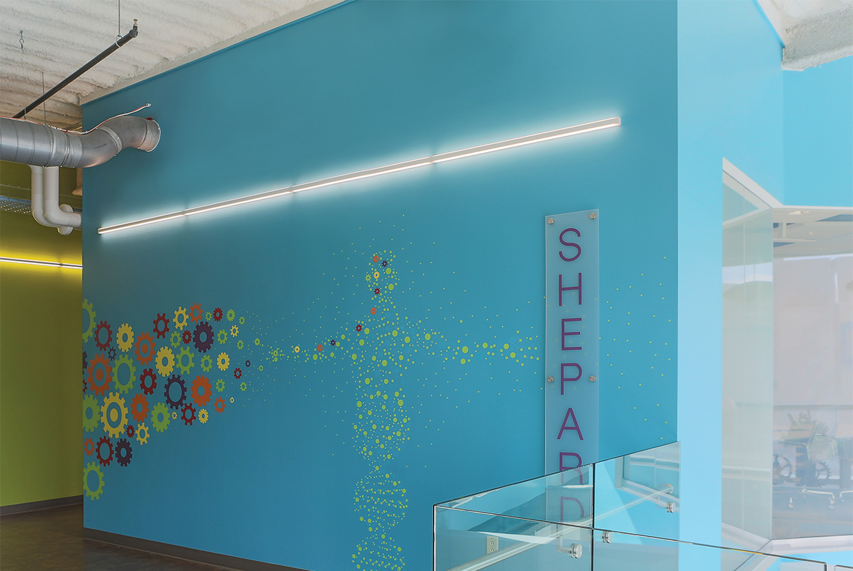 Sleight lights on painted blue wall in buisness. OSF Healthcare - Jump