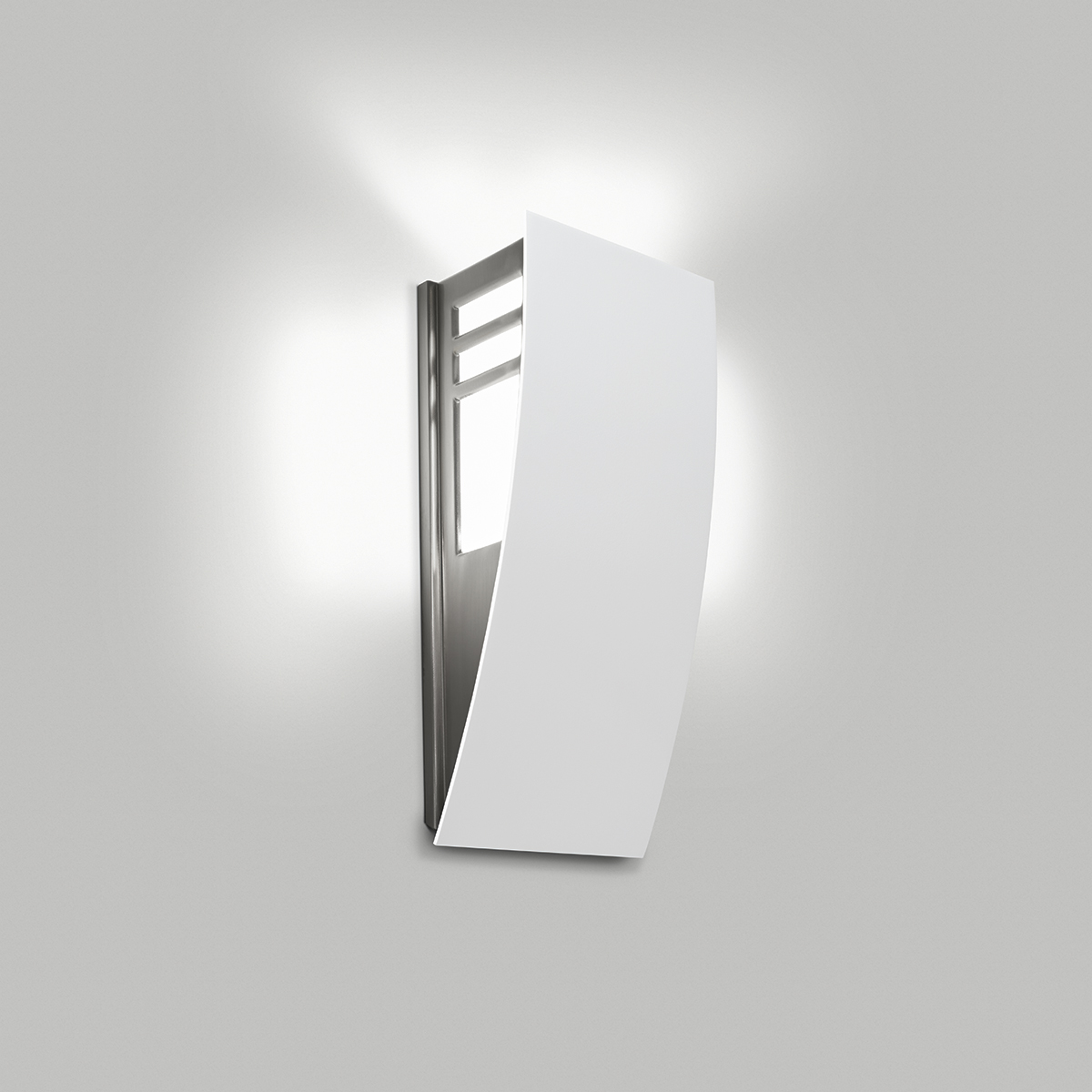 A wedge-shaped curved wall sconce with cutout accents in its solid body and uplighting