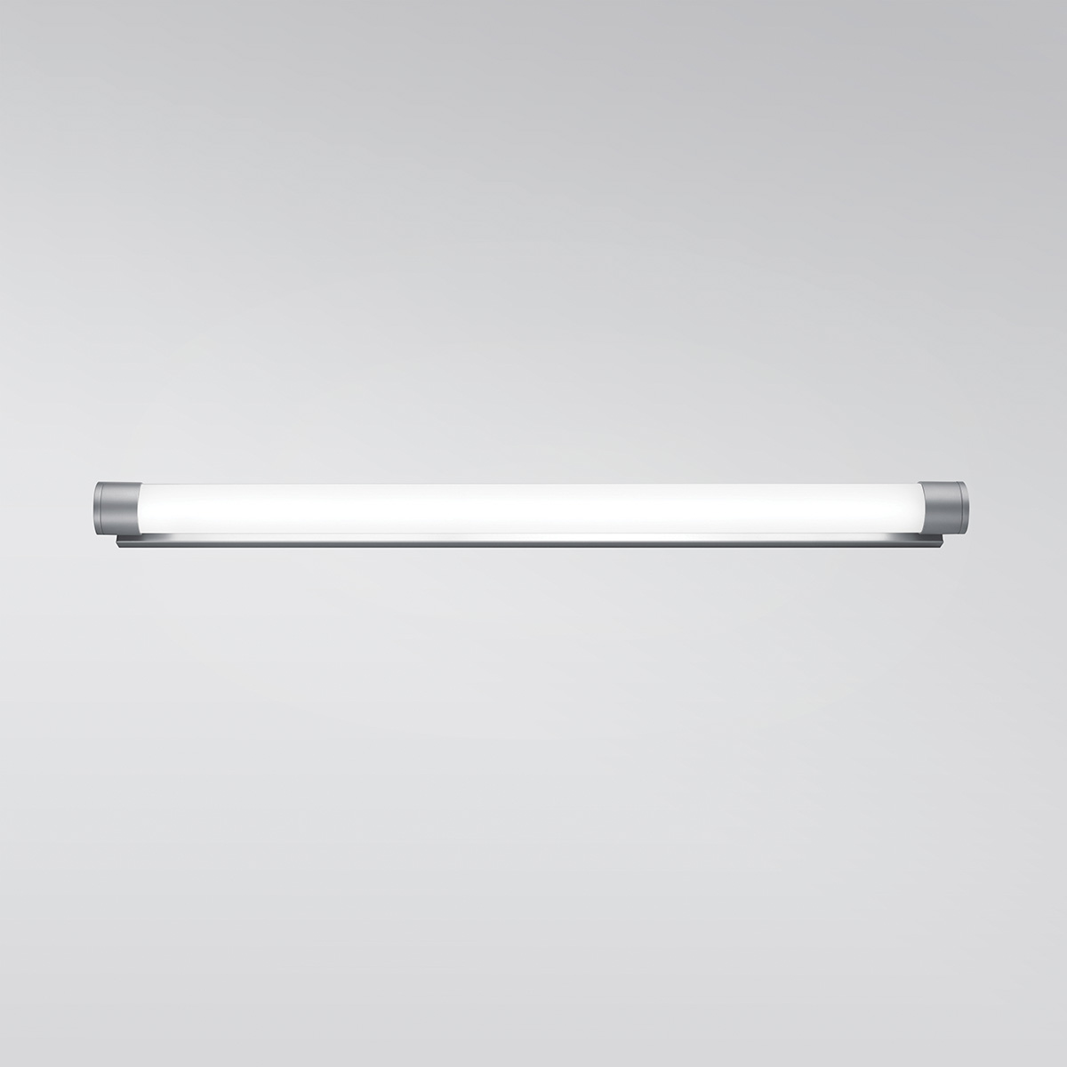 A luminous wall sconce in a thin tube shape with metal caps on each end