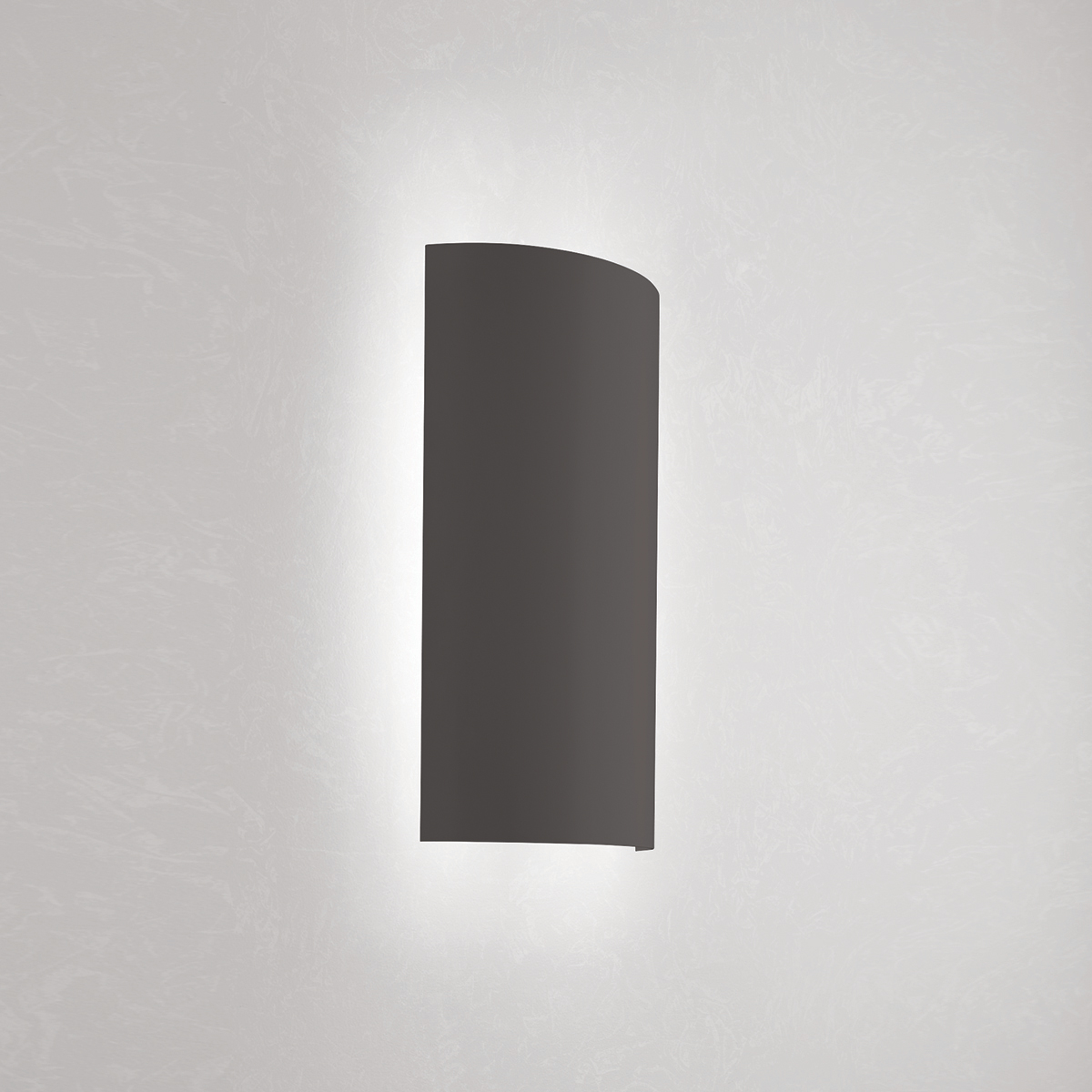 A rectangular wall sconce with a curved body 