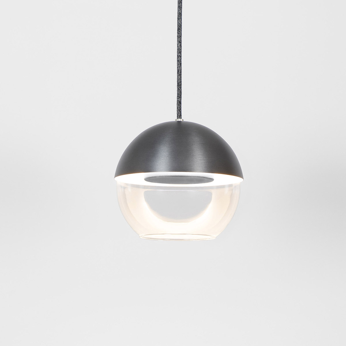 The 8” Muse pendant light globe utilizes a source disk that floats while reflecting indirect light.