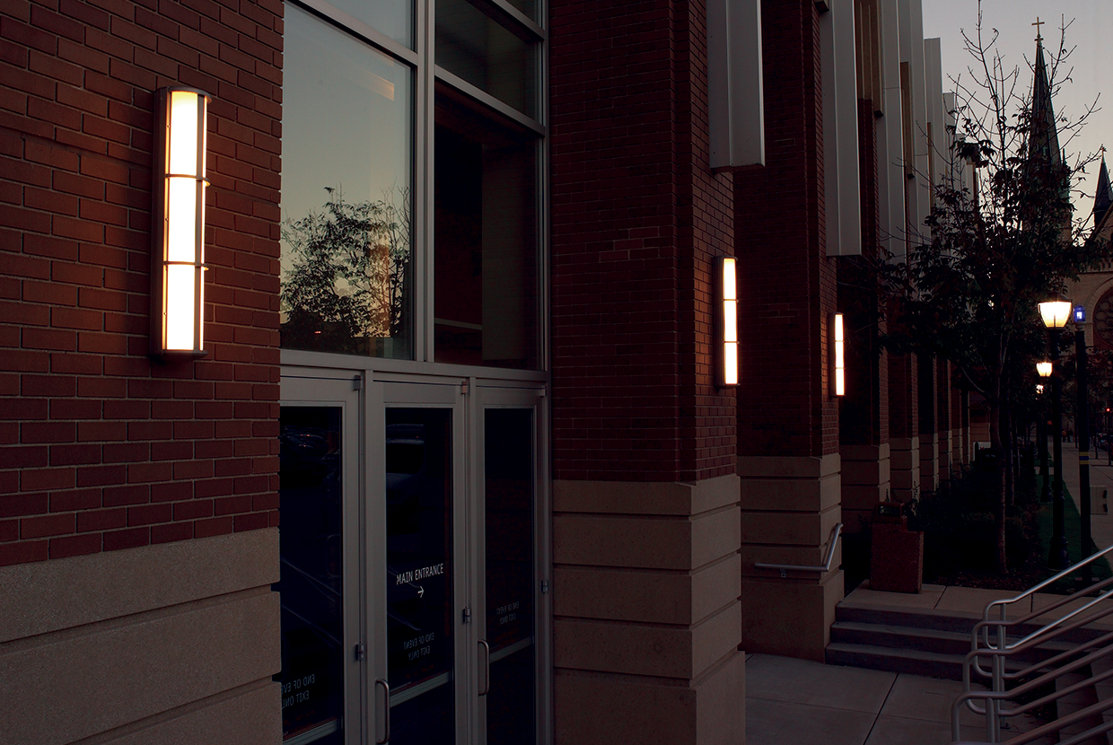 Avatar exterior lighting fixtures illuminate a campus library doorway with a classic, sophisticated aesthetic.