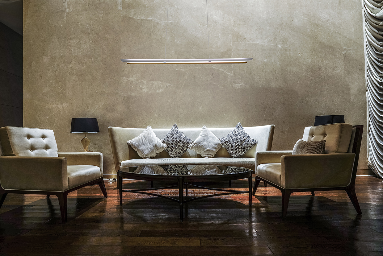 Linear pendant lighting in a waiting area of a hotel