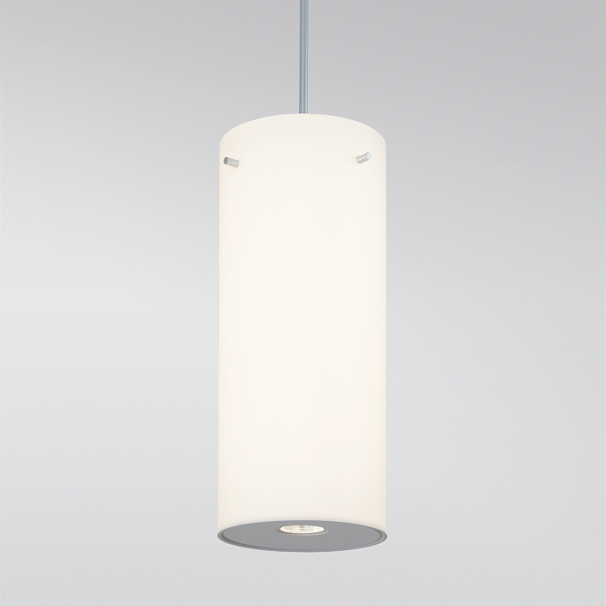 A large, luminous cylinder pendant with a pin accent