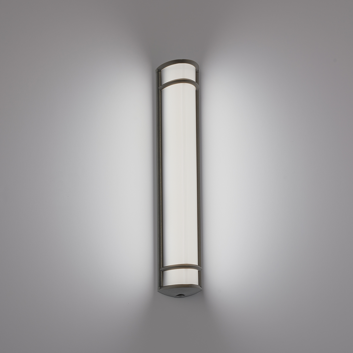 A luminous surface-mounted luminaire with a curved linear diffuser body and trim accents